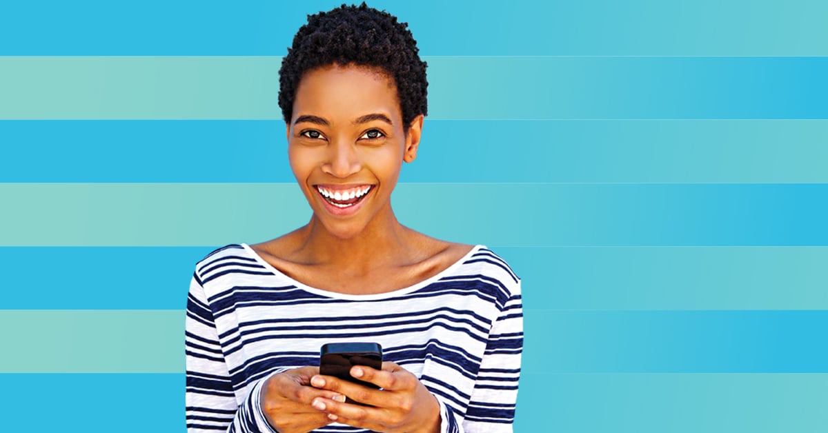 Smiling woman holding mobile phone